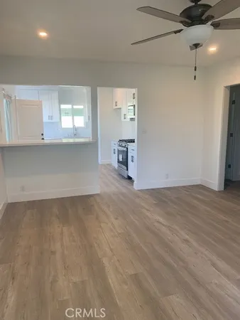 an empty room with windows and cabinet