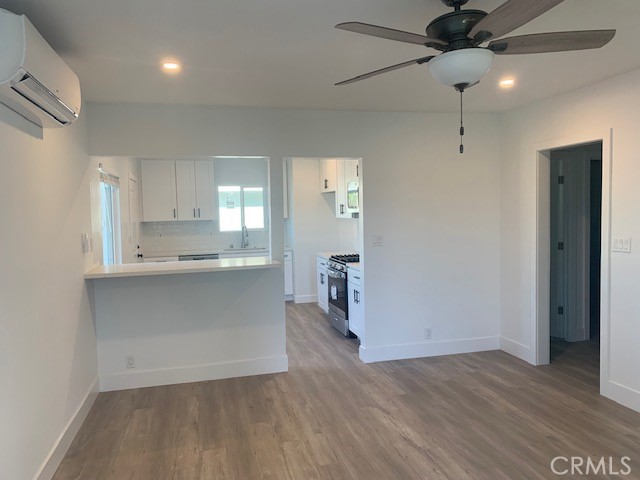 5340 South J Street Oxnard, CA 93033 - Photo 12 of 17 wooden floor in an empty room with a kitchen