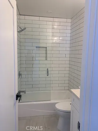 a bathroom with a shower and a toilet