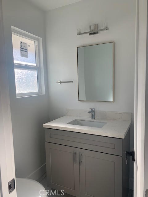 5340 South J Street Oxnard, CA 93033 - Photo 16 of 17 a bathroom with a toilet sink and mirror