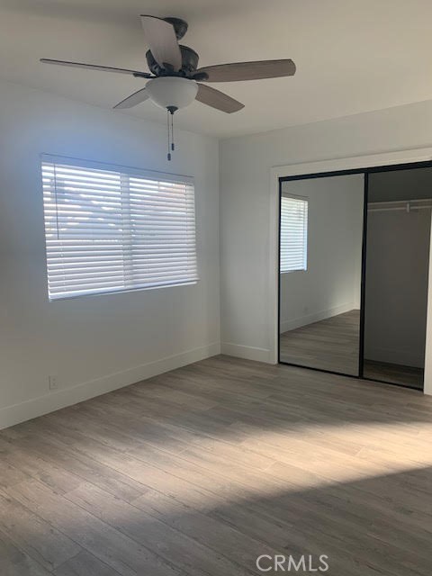 5340 South J Street Oxnard, CA 93033 - Photo 17 of 17 an empty room with wooden floor and windows