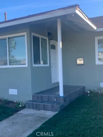 a view of house with backyard and garden