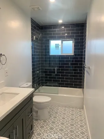 a bathroom with a toilet a sink and shower