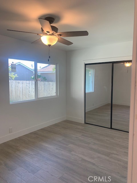 5340 South J Street Oxnard, CA 93033 - Photo 7 of 17 an empty room with wooden floor fan and windows