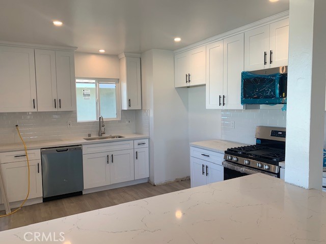 5340 South J Street Oxnard, CA 93033 - Photo 9 of 17 a kitchen with a sink stove top oven and cabinets