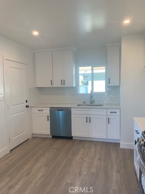 5340 South J Street Oxnard, CA 93033 - Photo 10 of 17 a kitchen with granite countertop white cabinets and white appliances
