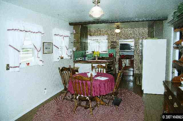 12930 Valley Springs Road Reno, NV 89511 - Photo 8 of 8 a living room with furniture a fireplace and a chandelier