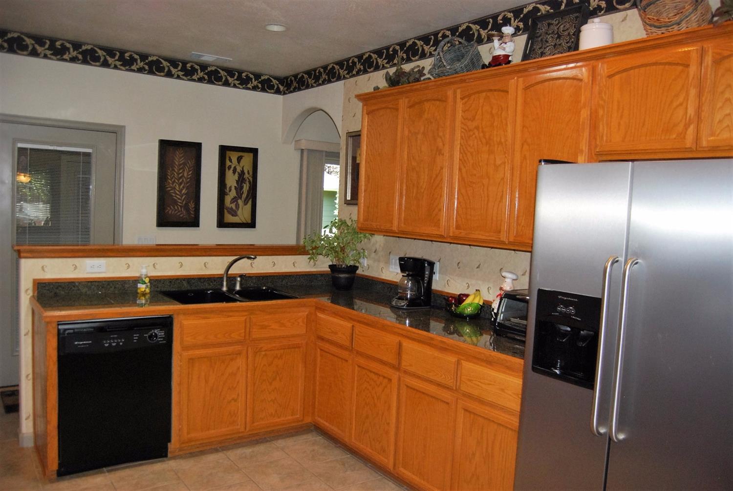 1136 Grouse Ridge Drive Central Point, OR 97502 - Photo 14 of 35 a kitchen with stainless steel appliances granite countertop a sink stove and refrigerator