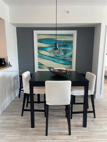 a view of a dining room with a table and chairs