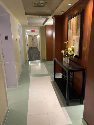 a lobby with furniture and a potted plant