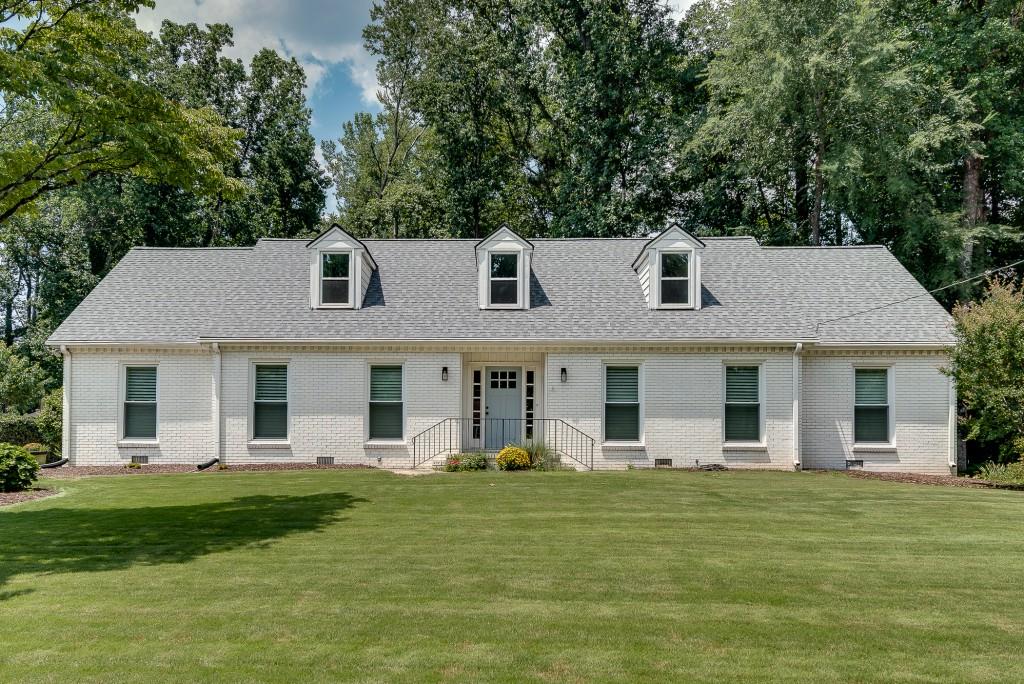 a front view of a house with a garden