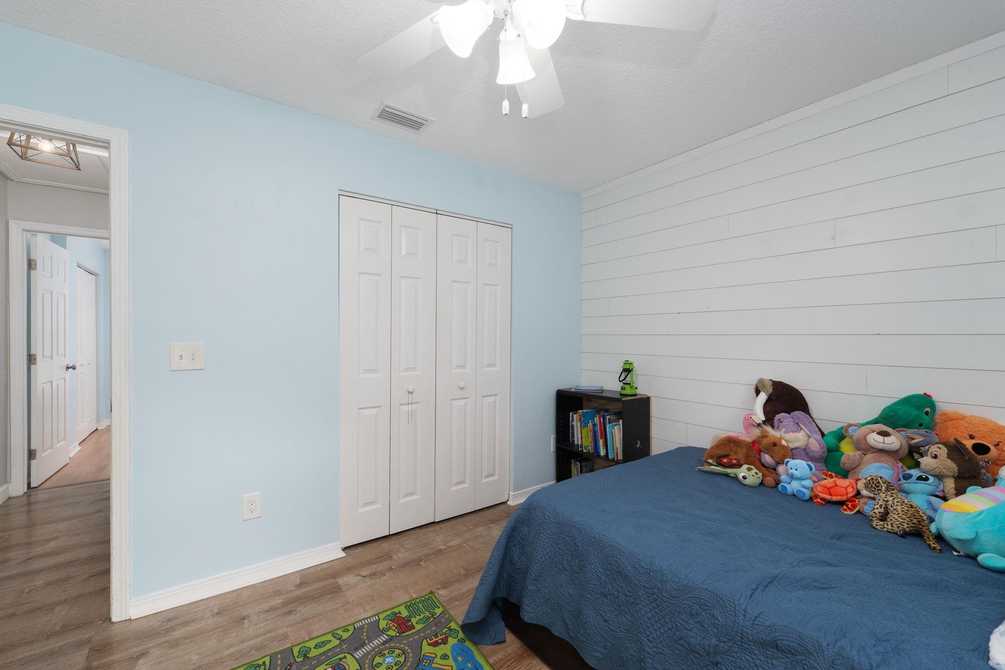 133 Mohegan Road St. Augustine, FL 32086 - Photo 18 of 24 a bedroom with a bed and a chandelier