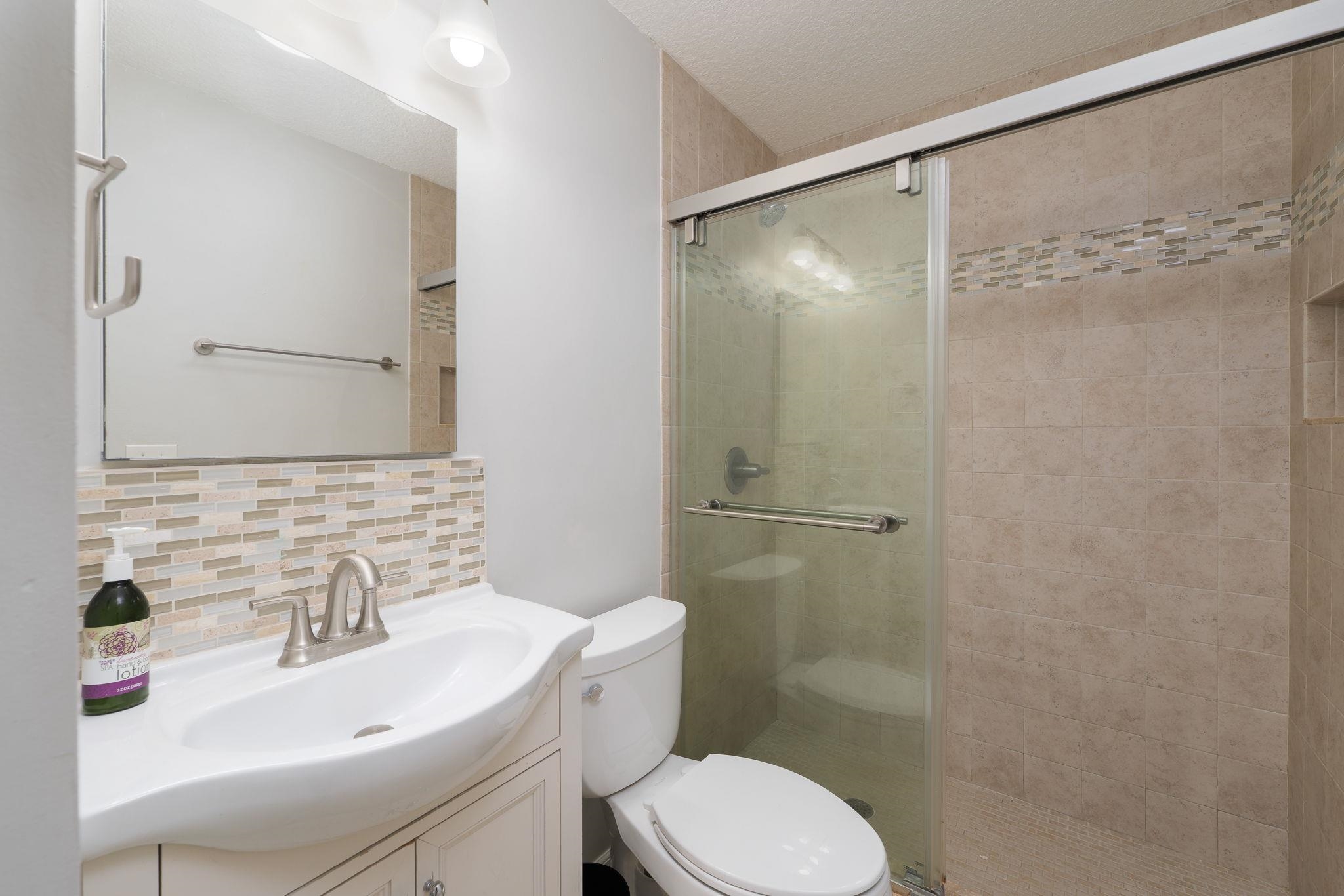133 Mohegan Road St. Augustine, FL 32086 - Photo 19 of 24 a bathroom with a sink toilet and shower
