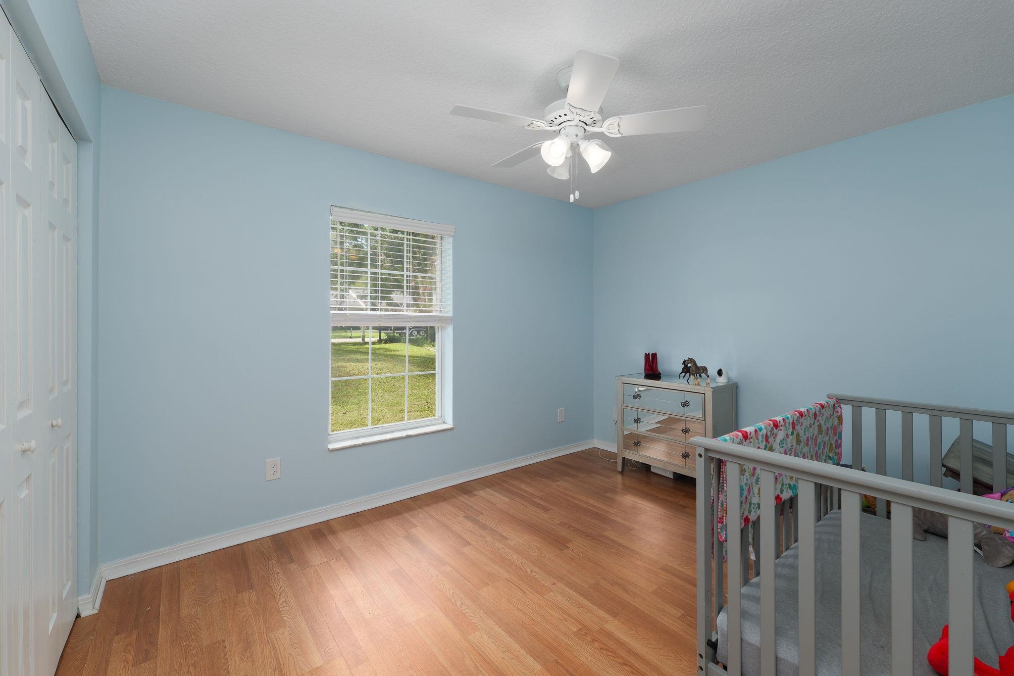 133 Mohegan Road St. Augustine, FL 32086 - Photo 20 of 24 a bedroom with a bed and wooden floor