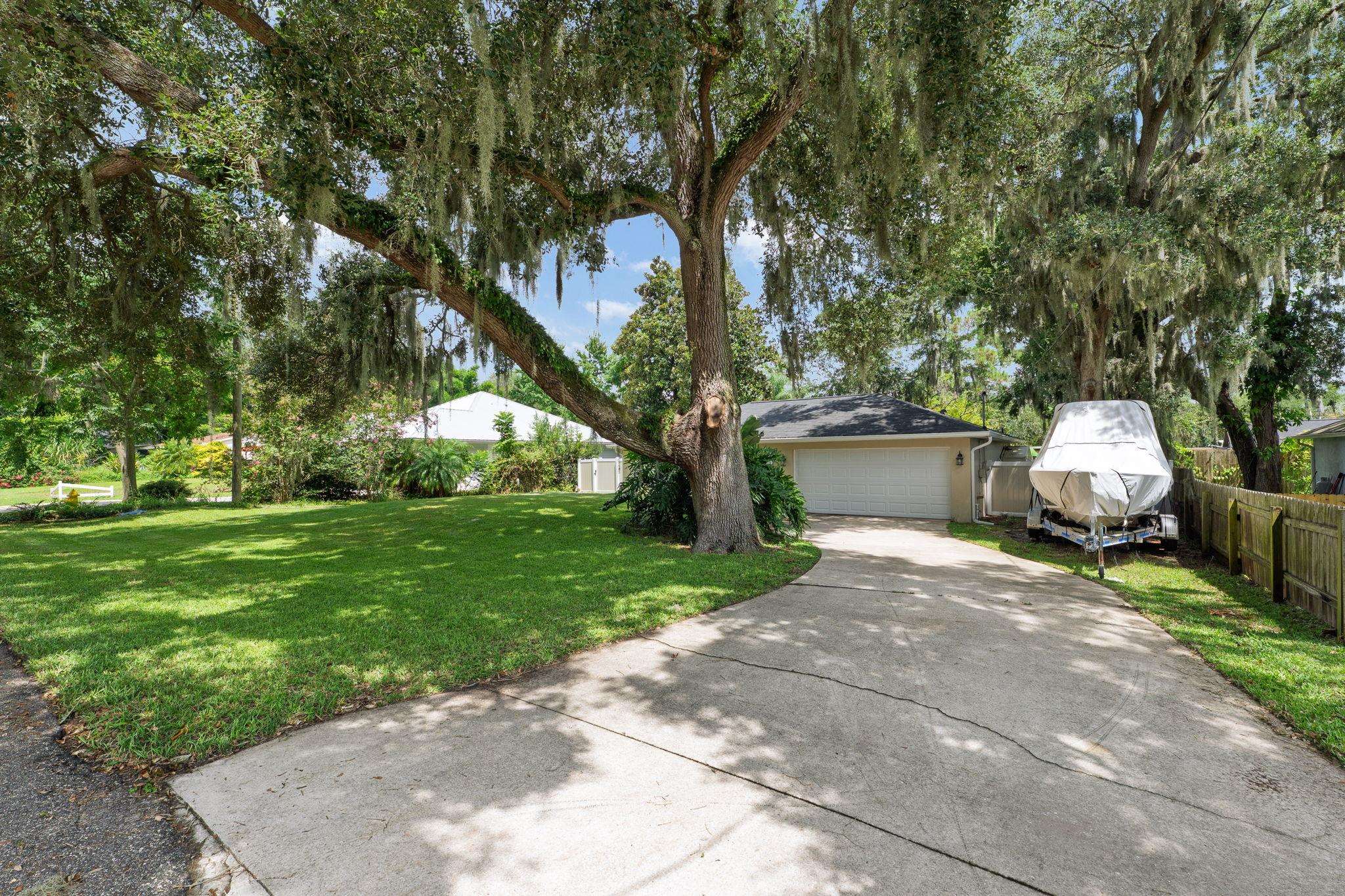 133 Mohegan Road St. Augustine, FL 32086 - Photo 3 of 24 a view of backyard of house with outdoor seating and green space