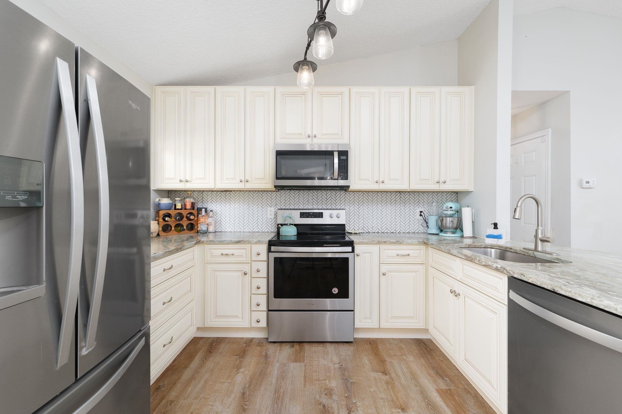 133 Mohegan Road St. Augustine, FL 32086 - Photo 10 of 24 a kitchen with stainless steel appliances granite countertop a stove a refrigerator and a granite counter tops