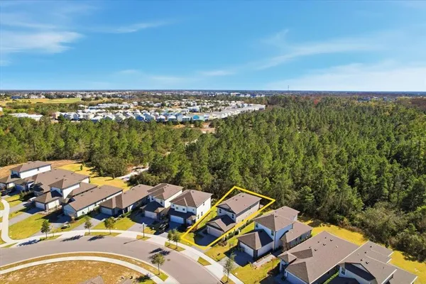 an aerial view of a house with a lake view