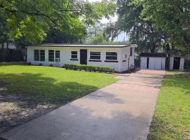 a front view of a house with a garden and porch