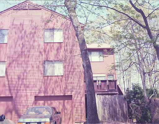 132 Mountain Gate Road, Unit 58 Ashland, MA 01721 - Photo 1 of 1 a front view of a house with a tree