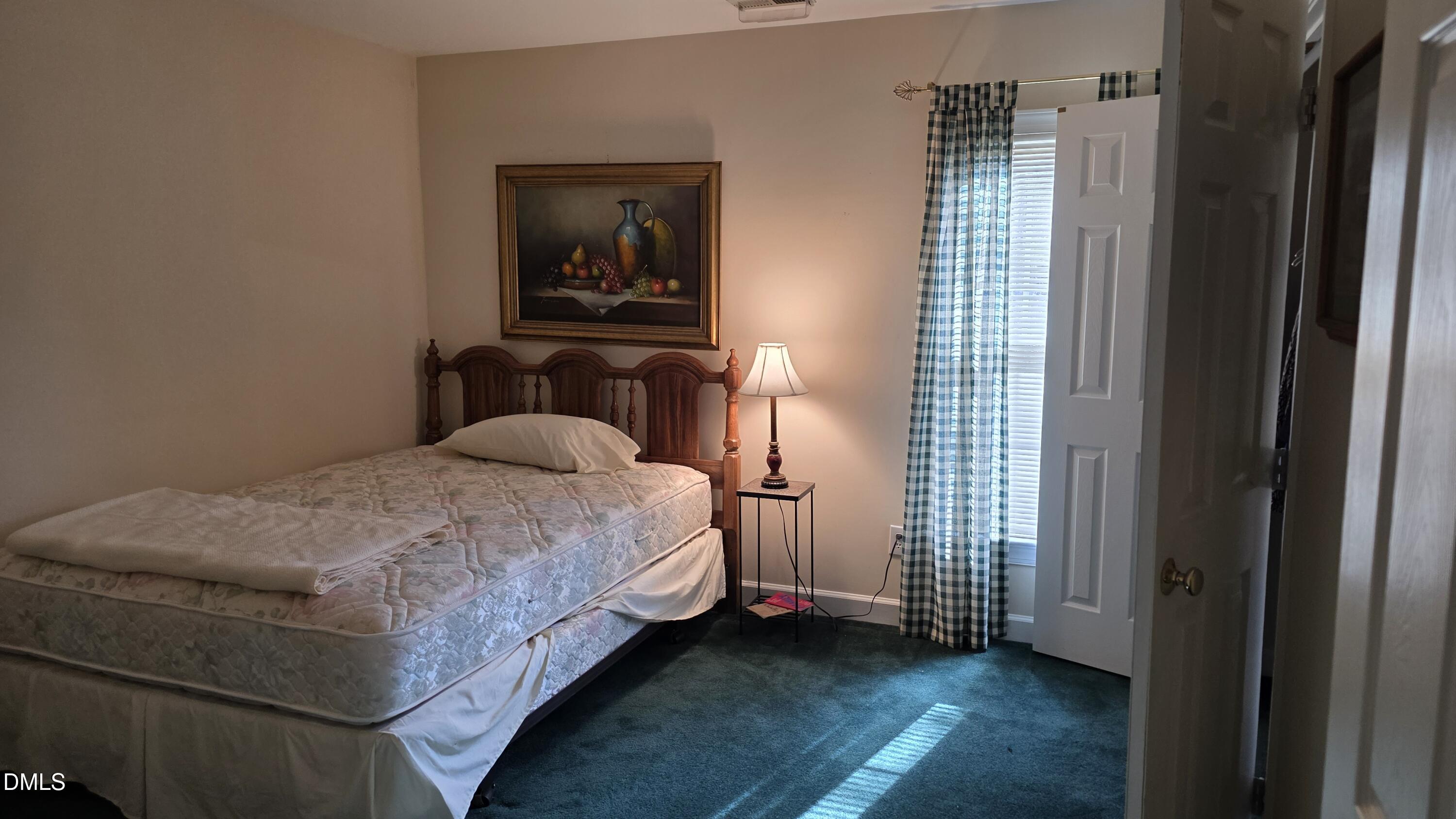 3300 Kemble Ridge Drive Wake Forest, NC 27587 - Photo 11 of 12 a bedroom with a bed and a window
