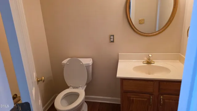 a bathroom with a sink mirror and toilet