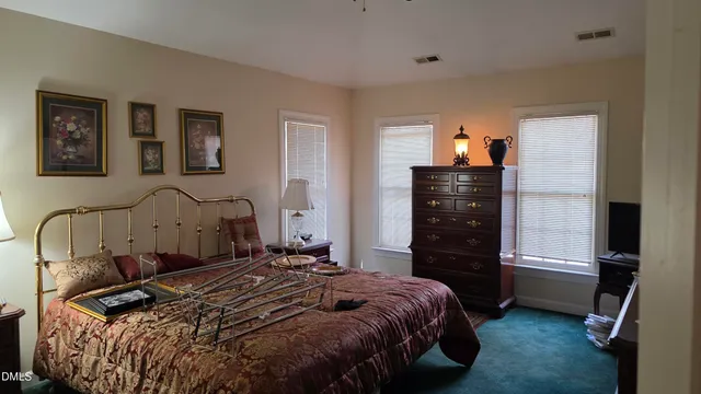 a bedroom with a bed and a television