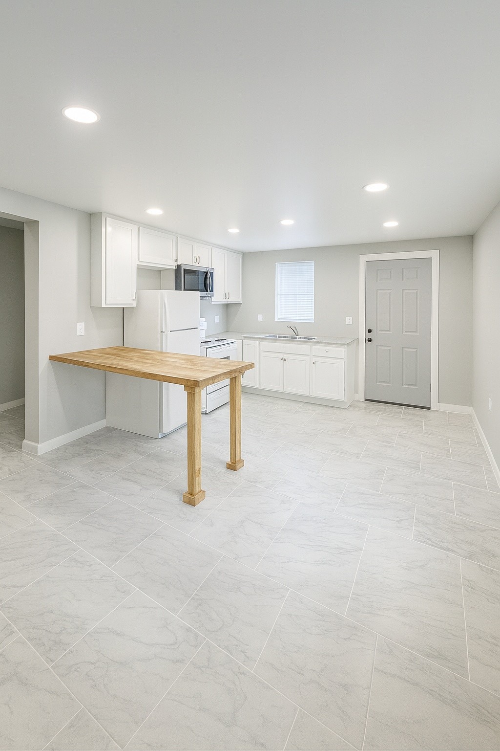 605 Montgomery Street Cowan, TN 37318 - Photo 2 of 7 a large white kitchen with kitchen island a sink a stove a dining table and chairs