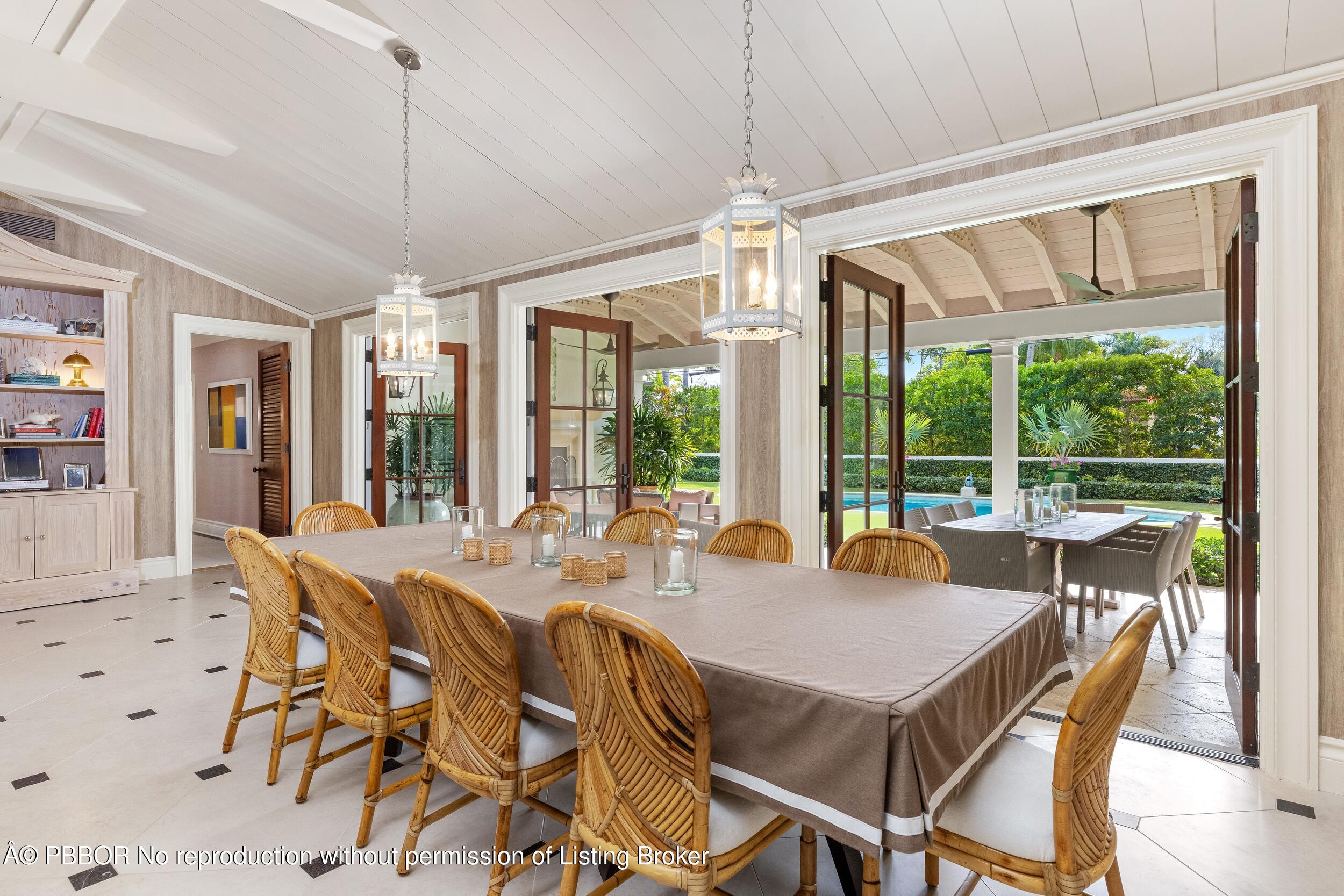 258 List Road Palm Beach, FL 33480 - Photo 11 of 45 a view of a dining room with furniture large windows and wooden floor