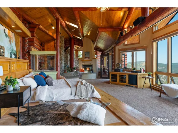 a living room with furniture a ceiling fan and a large window