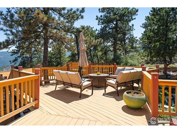 a view of a chair and table on the roof deck