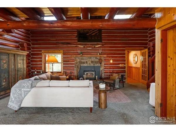 a living room with furniture a fireplace and a table