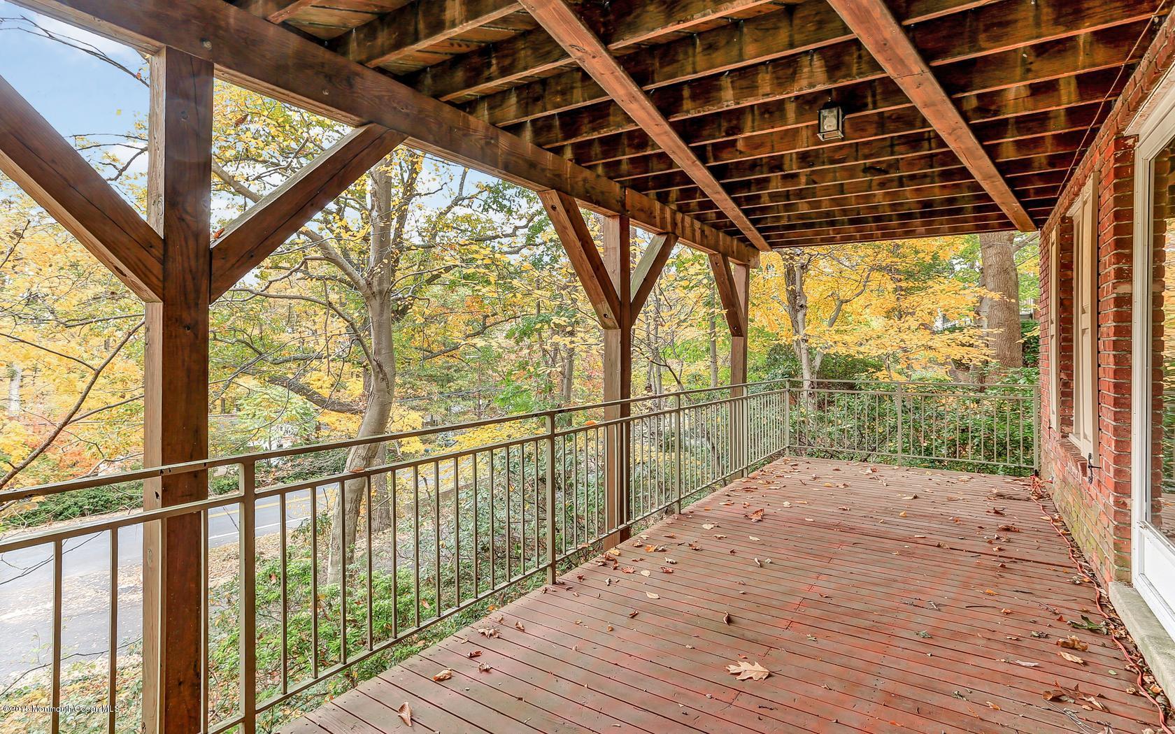 68 Upper Prospect Road Atlantic Highlands, NJ 07716 - Photo 5 of 34 a view of porch with wooden floor and fence next to a yard