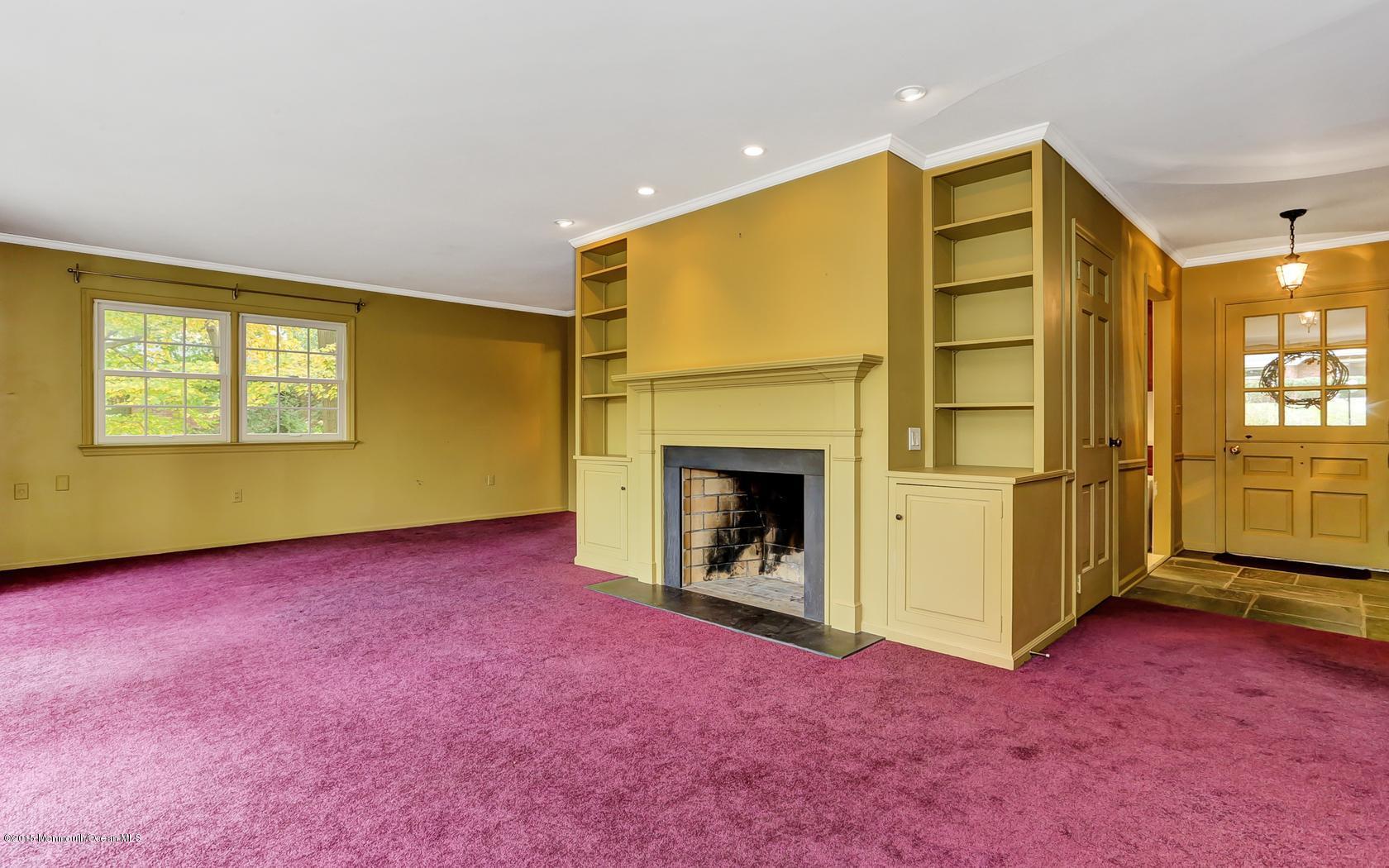 68 Upper Prospect Road Atlantic Highlands, NJ 07716 - Photo 8 of 34 a view of an empty room with a fireplace and a window