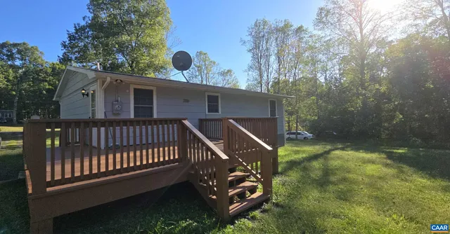 a balcony with wooden floor and fence