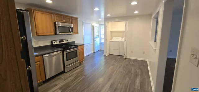 a kitchen with stove cabinets and wooden floor