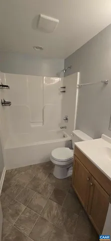 a bathroom with a toilet a sink and bathtub