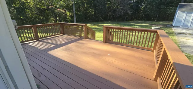 a view of outdoor space with deck and yard