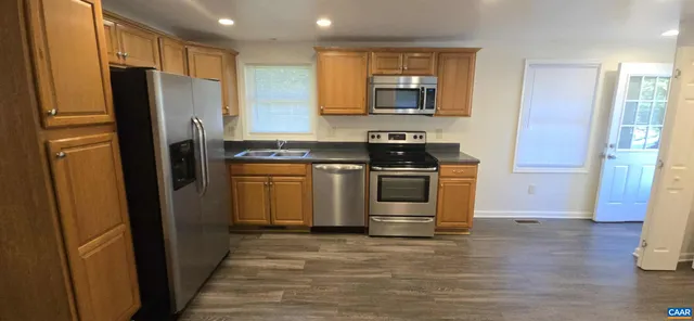 a kitchen with stainless steel appliances a refrigerator stove and sink