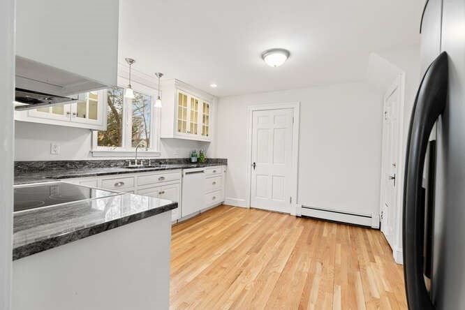 84 Gleason Road Lexington, MA 02420 - Photo 14 of 32 a kitchen with granite countertop a sink cabinets and stainless steel appliances