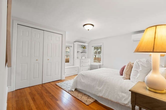 84 Gleason Road Lexington, MA 02420 - Photo 18 of 32 a bedroom with a bed and a painting on the wall