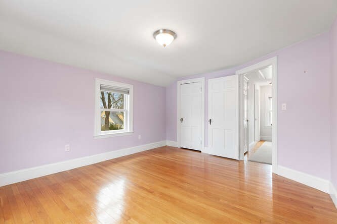 84 Gleason Road Lexington, MA 02420 - Photo 22 of 32 a view of an empty room with wooden floor and a window