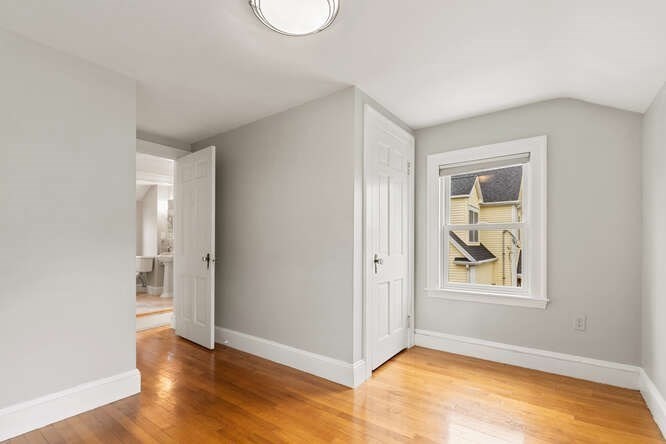 84 Gleason Road Lexington, MA 02420 - Photo 24 of 32 a view of an empty room with wooden floor and a window