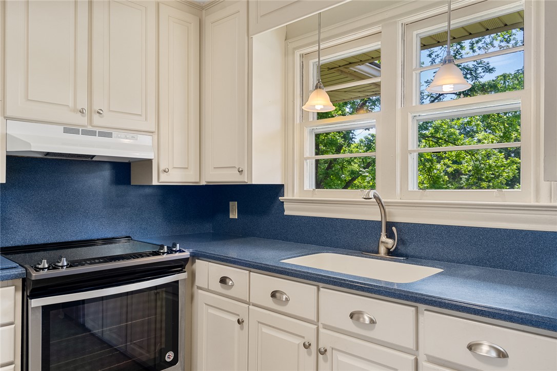 1509 869 Anderson, SC 29621 - Photo 17 of 45 Culinary haven with plentiful cabinetry, a modern range, and a window framing lush outdoor views.