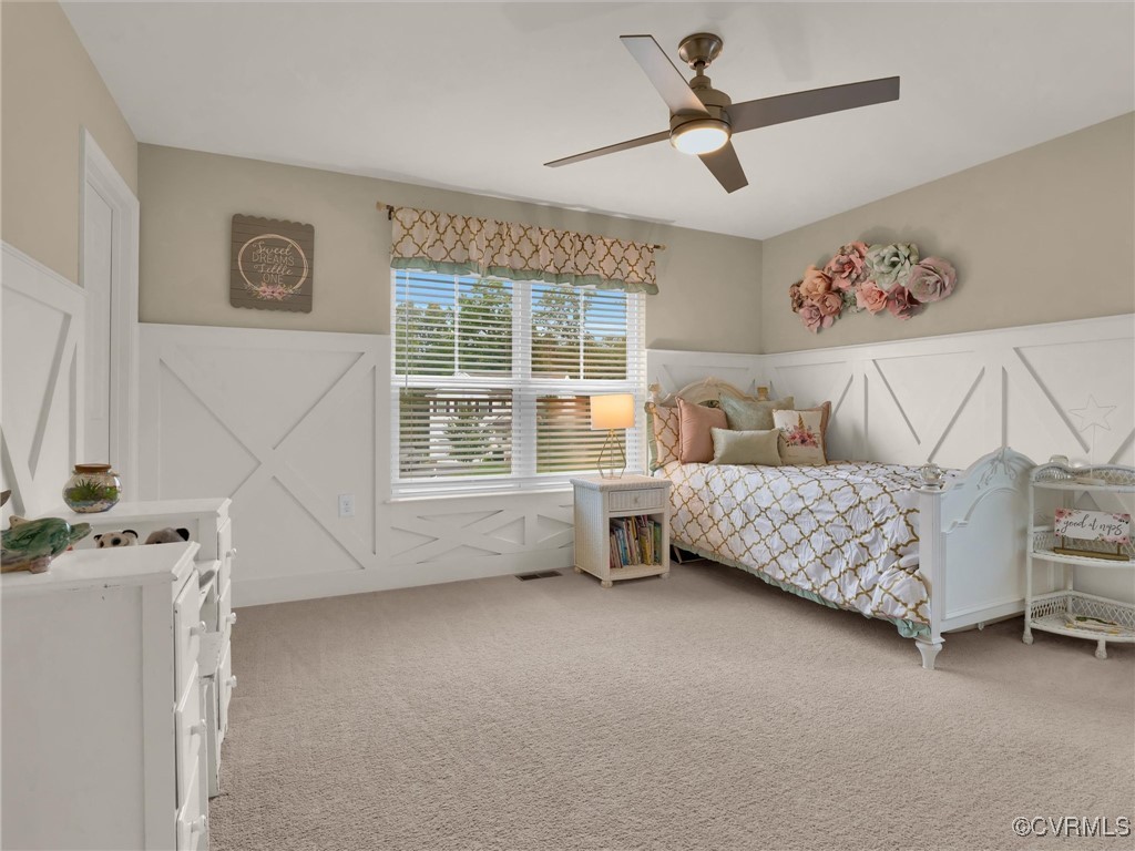 10168 Kellys Bluff Run Ashland, VA 23005 - Photo 30 of 50 a bedroom with a bed next to a window and a chandelier