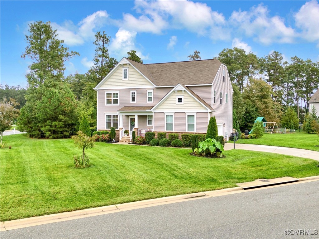 10168 Kellys Bluff Run Ashland, VA 23005 - Photo 3 of 50 a front view of a house with a yard