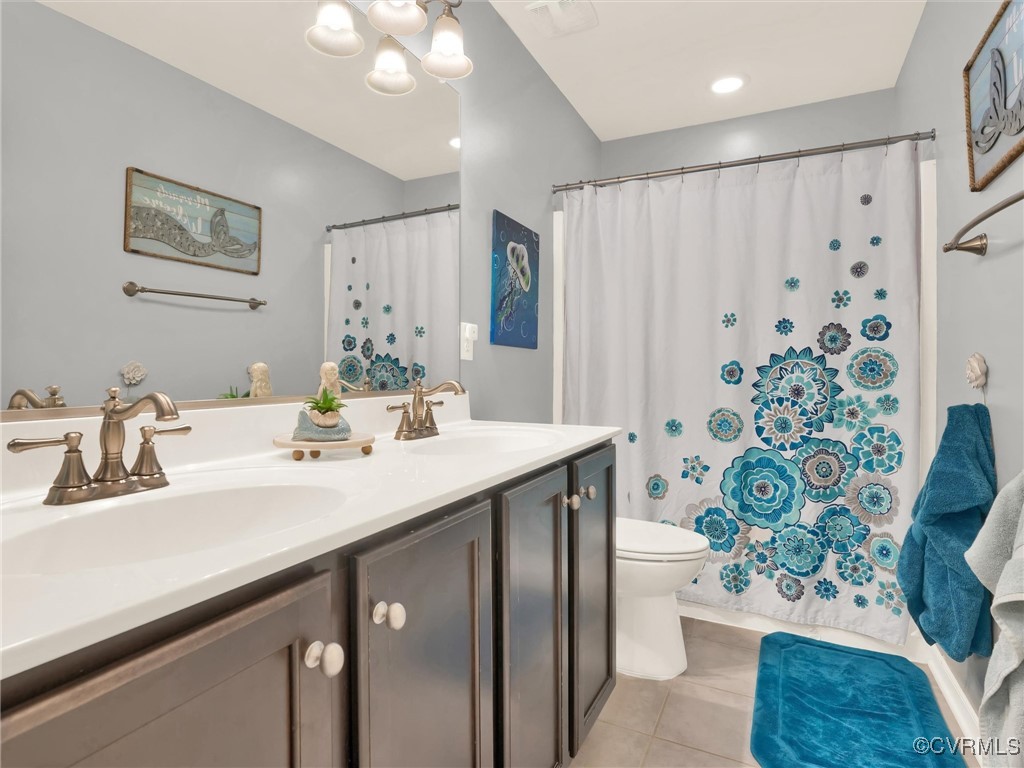 10168 Kellys Bluff Run Ashland, VA 23005 - Photo 34 of 50 a bathroom with a sink a toilet and shower curtain