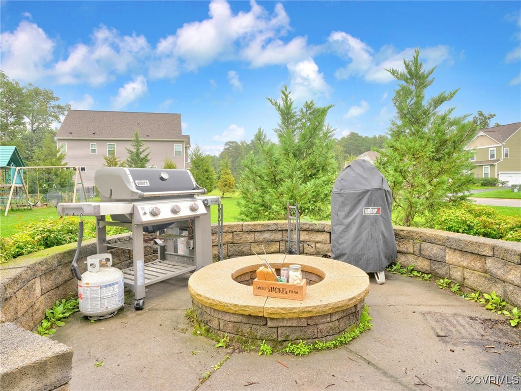 10168 Kellys Bluff Run Ashland, VA 23005 - Photo 42 of 50 a view of a patio with table and chairs potted plants with wooden fence