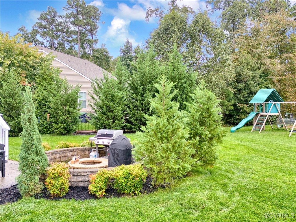 10168 Kellys Bluff Run Ashland, VA 23005 - Photo 43 of 50 a view of backyard with table and chairs and potted plants