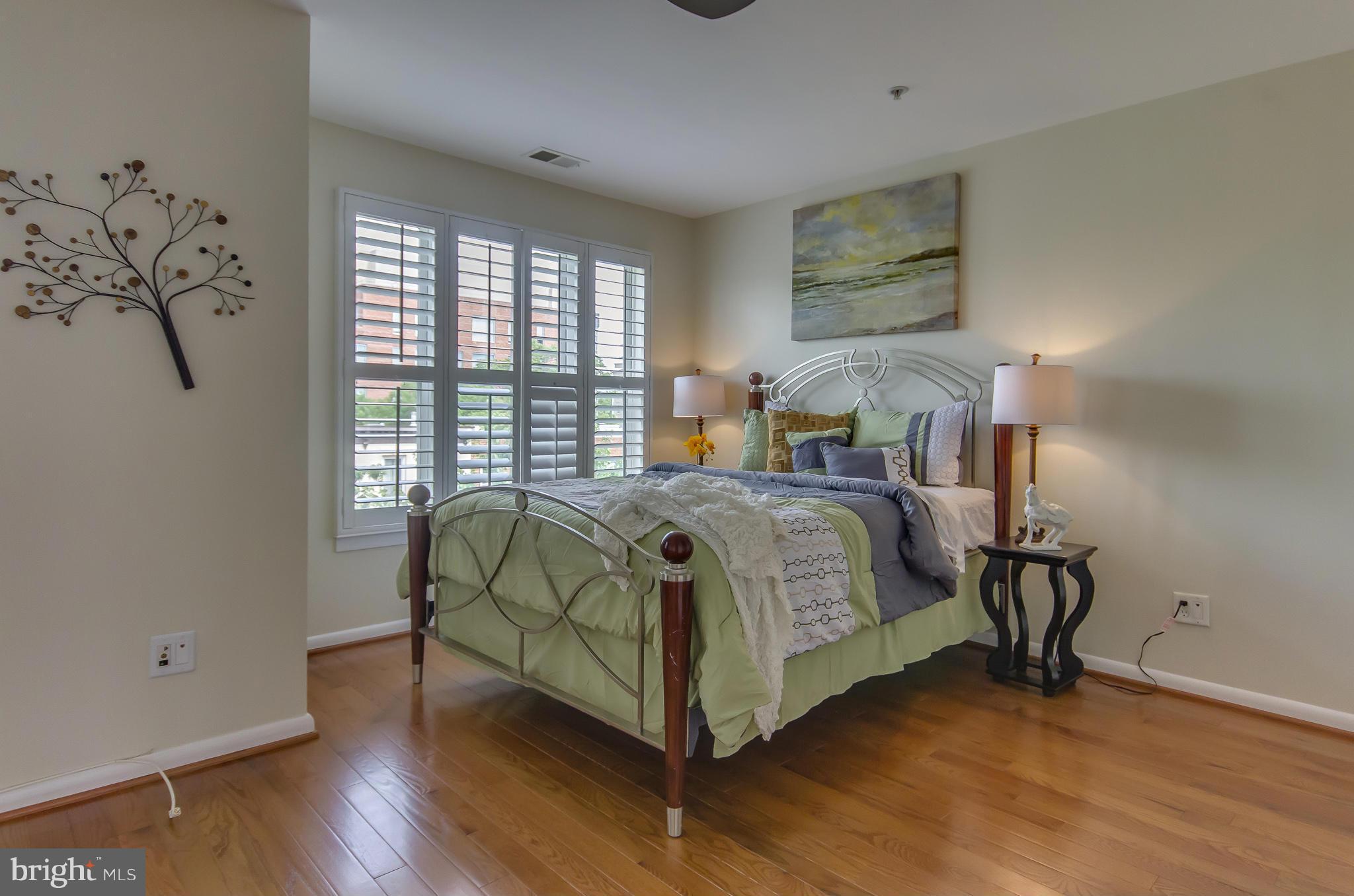 2116 12th Street Northwest Washington, DC 20009 - Photo 14 of 30 a bedroom with a bed and wooden floor