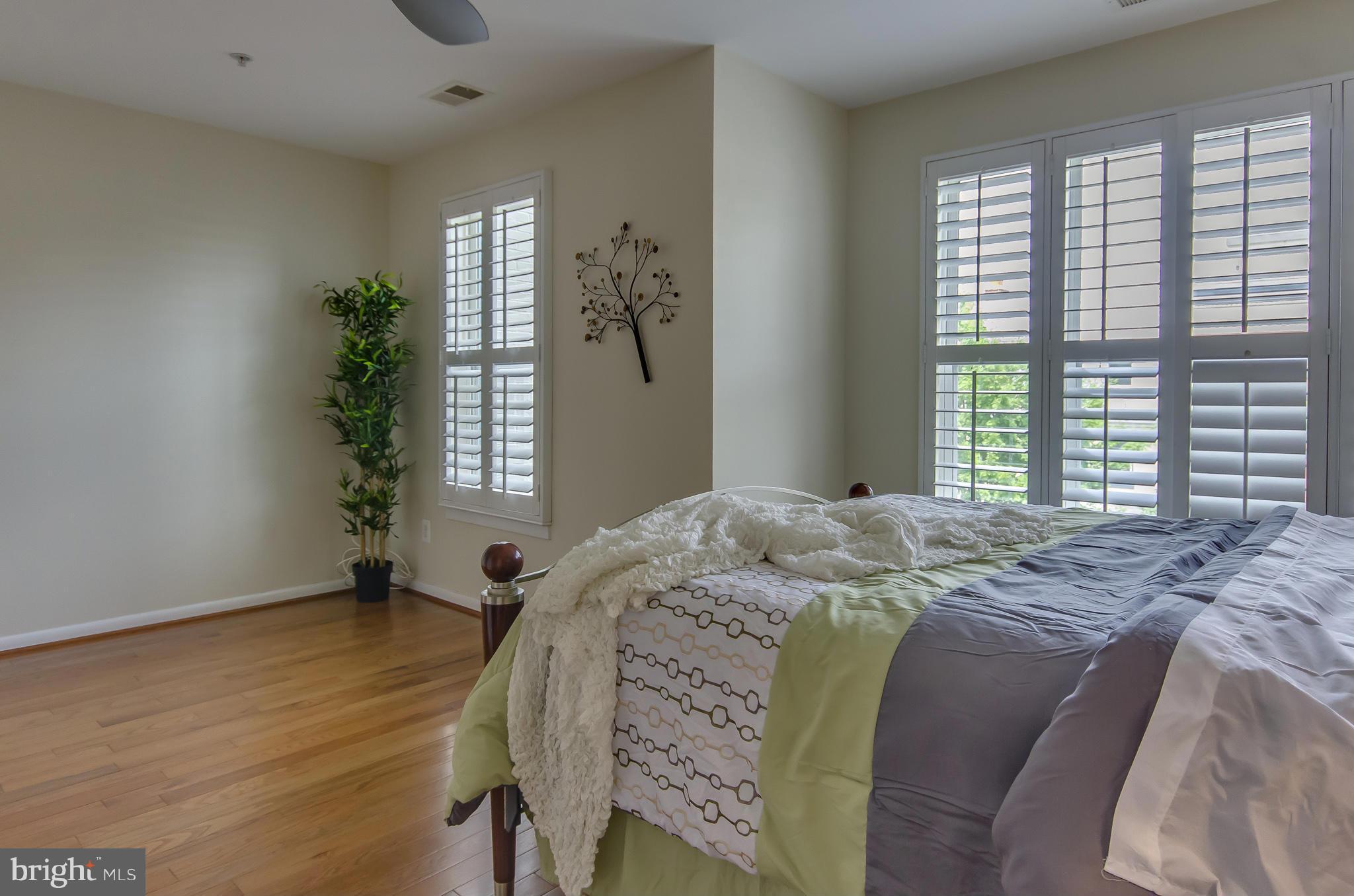 2116 12th Street Northwest Washington, DC 20009 - Photo 15 of 30 a bed sitting in a bedroom next to a window